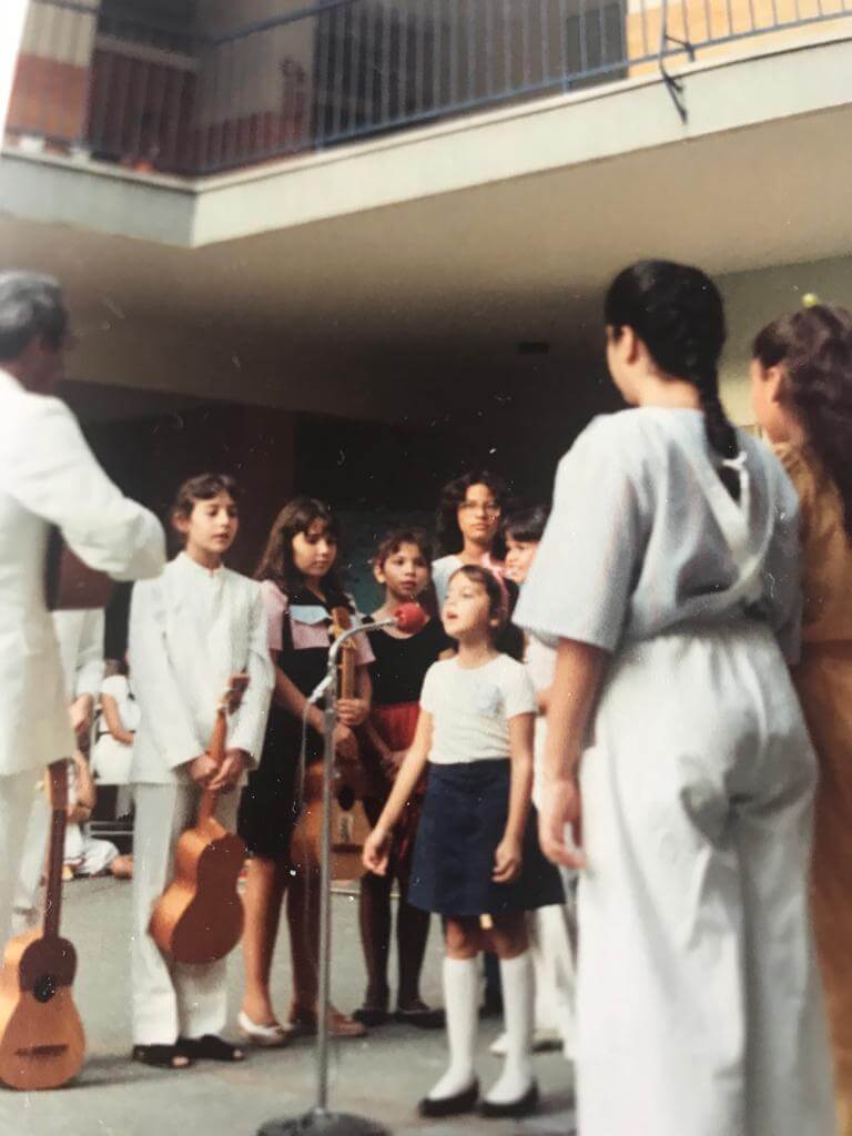 Mayré Martínez de joven cantando en un acto del colegio